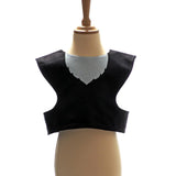 Front view of black cat tabard on a stand against a plain white background.