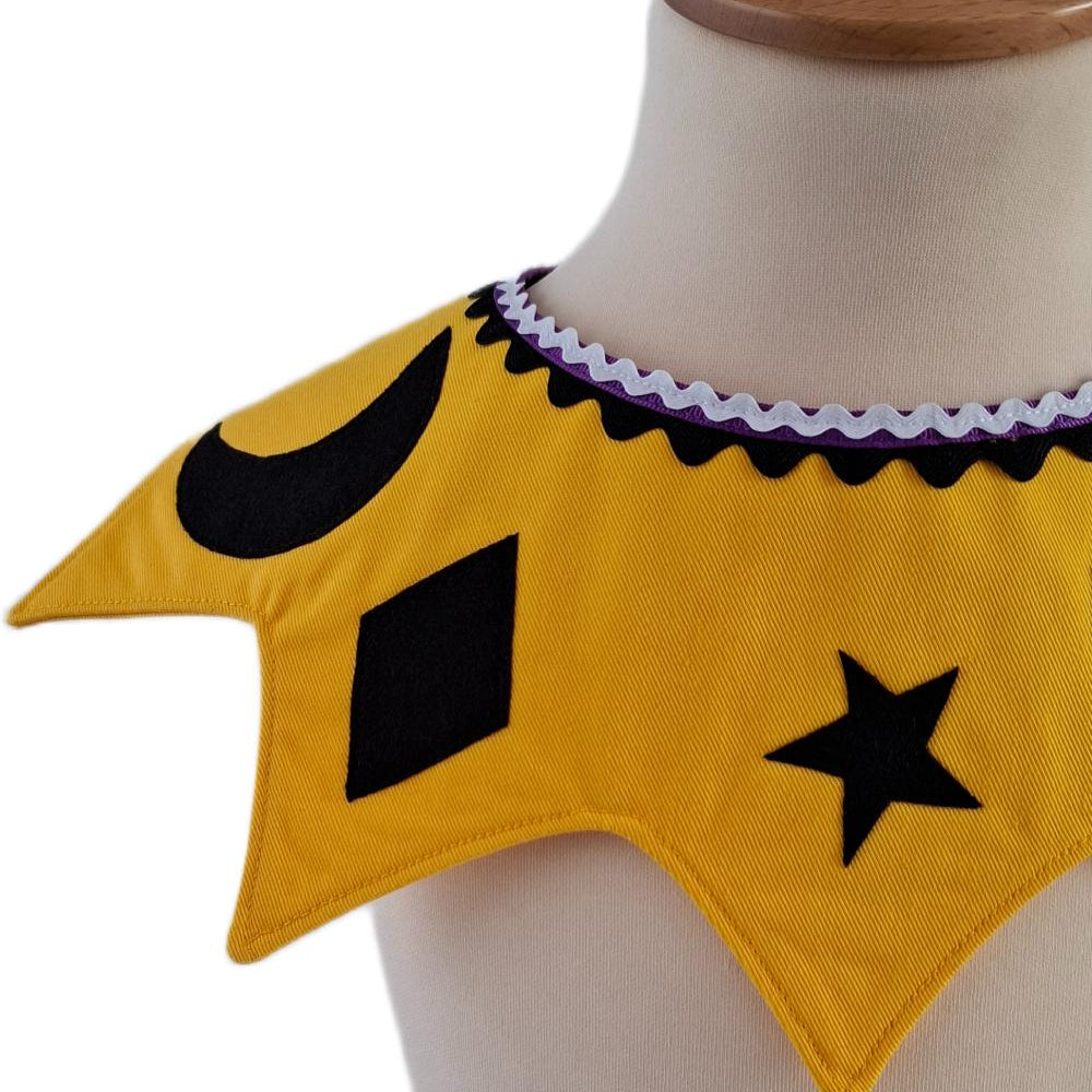 Close up of front view of the celestial moon and stars kids costume collar in sunbeam yellow on a stand against a white background.