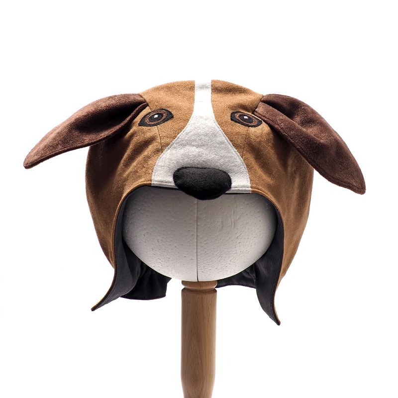 Front view of the floppy eared dog hat on a stand against a white background.