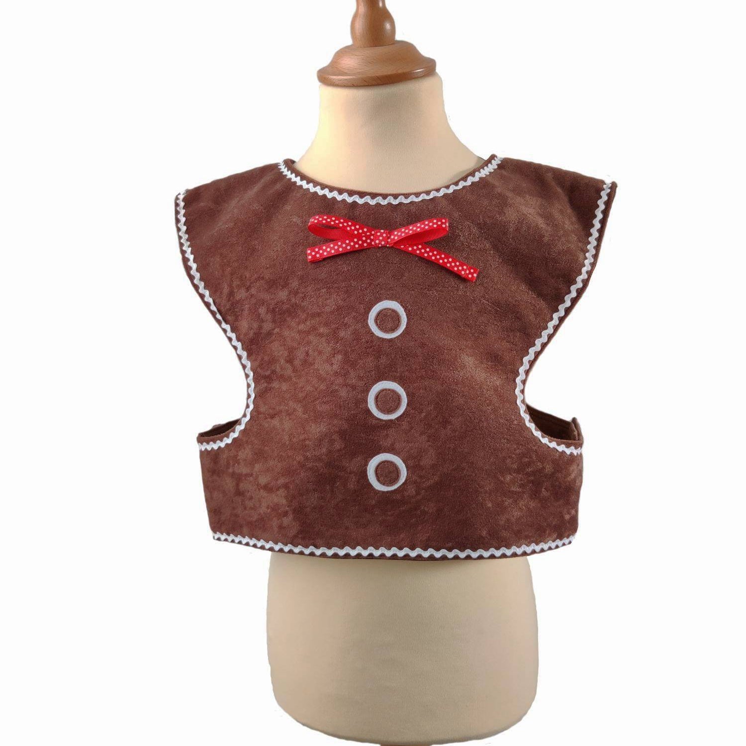 Front view of the gingerbread man tabard on a stand against a white background.