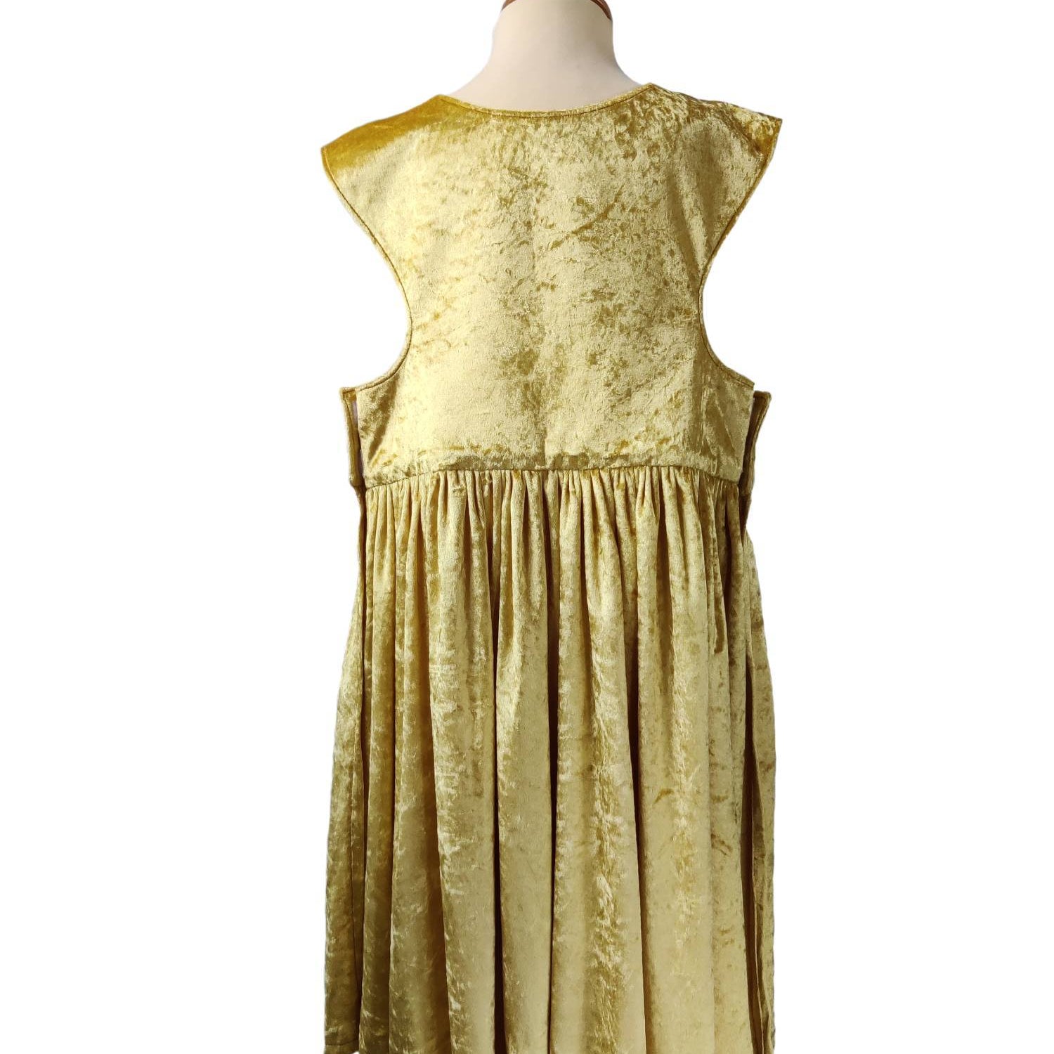 Back view of the gold royal fairytale dress on a stand