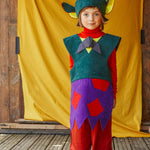 A child wearing the fairytale troll hat and tabard.