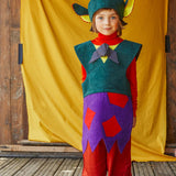 A child wearing the fairytale troll hat and tabard.
