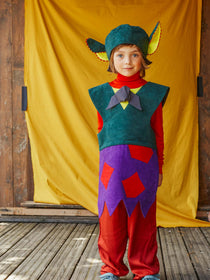 A child wearing the fairytale troll hat and tabard.