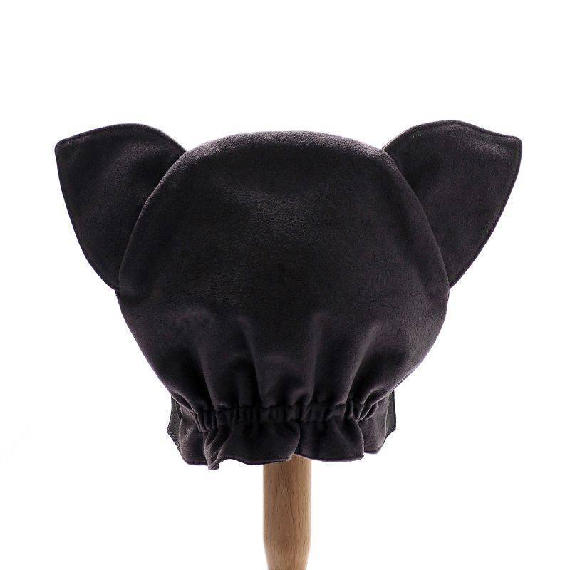 Back view of the grey wolf hat on a stand against a white background.