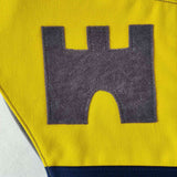 Close up of appliqued castle design on the knight tabard