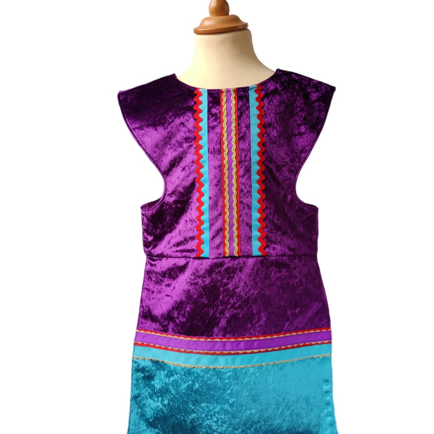 Front view of purple royal fairytale tabard on a stand