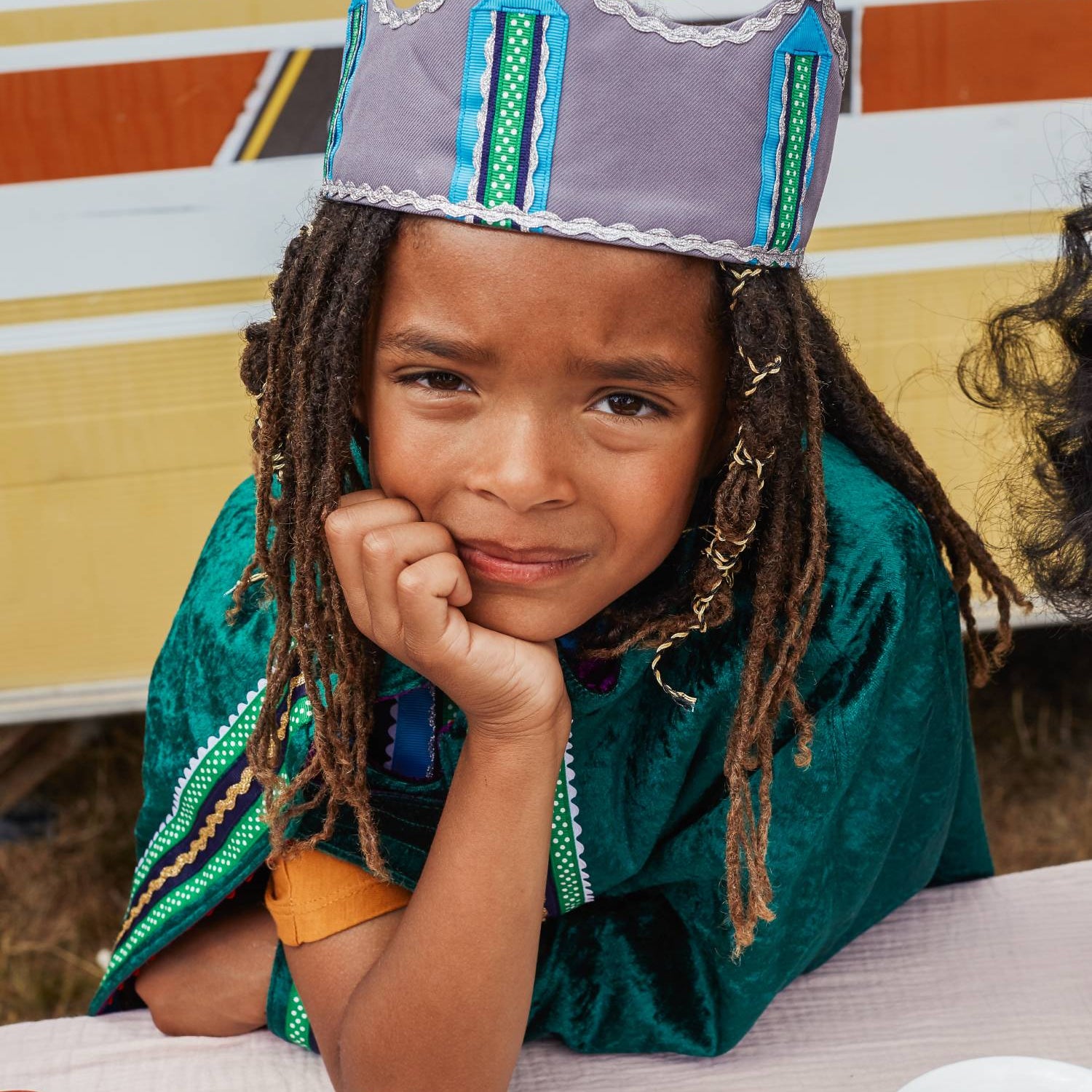 Boy wearing the reversible emerald cape and silver fairytale crown