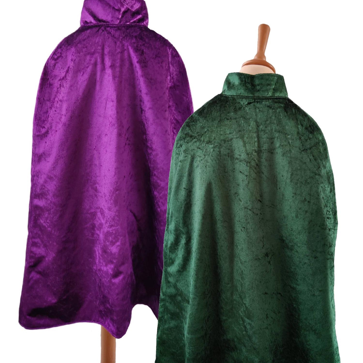 2 back view images of the emerald side and purple side of the reversible purple & emerald cape on stands