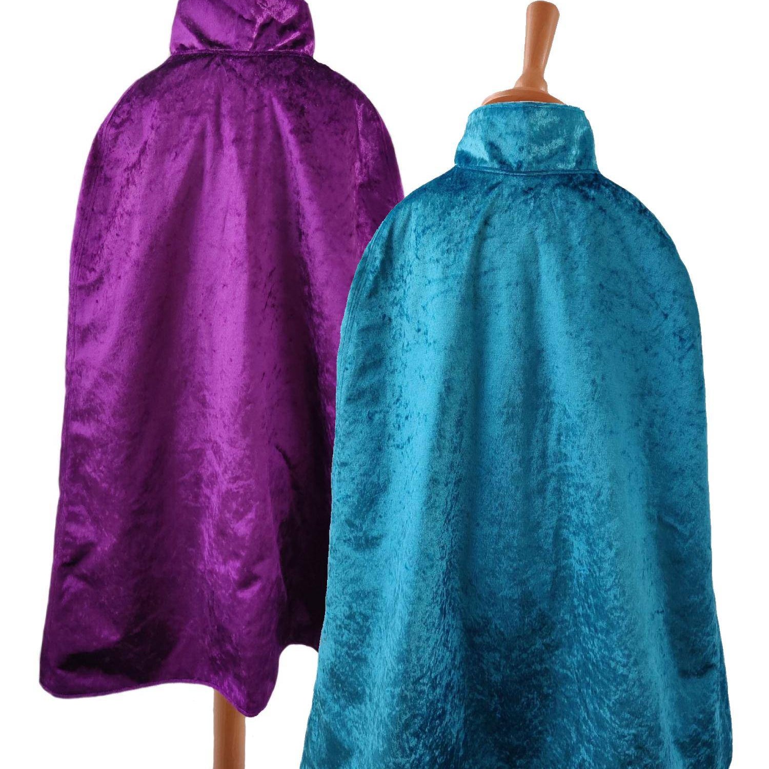 2 back view images of the purple side and turquoise side of the reversible purple & turquoise cape on stands