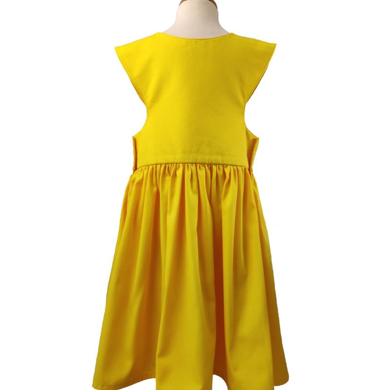 Back view of the sunshine yellow pinafore dress on a stand against a white background.