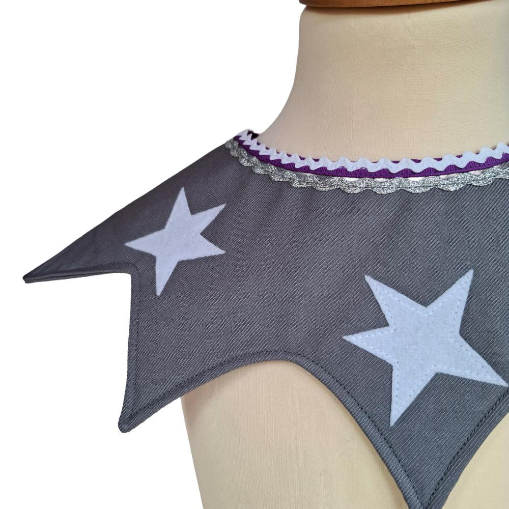 Close up of front view of the twinkling stars kids costume collar in silver on a stand against a white background.