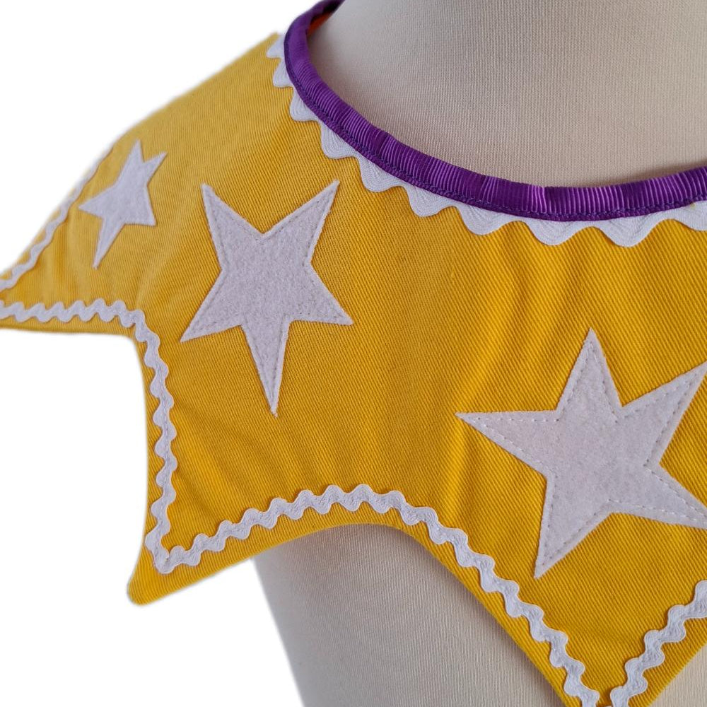 Close up of front view of the twinkling stars kids costume collar in sunbeam yellow on a stand against a white background.