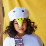 Child wearing the white duck hat and white feathered bird cape.