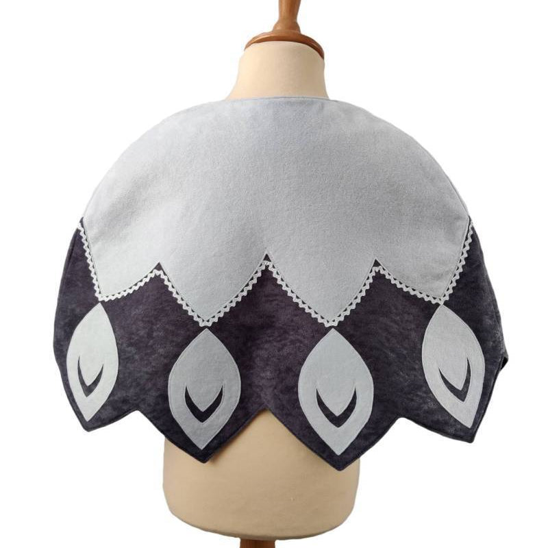 Back view of white feathered bird cape on a stand against white background.