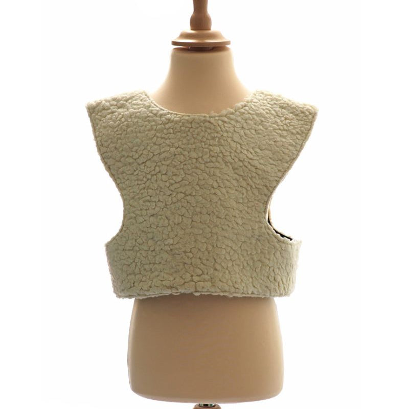 Front view of the woolly sheep tabard on a stand against a white background.